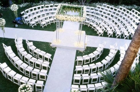 The focal point of the ceremony being a square center arbor decorated with a